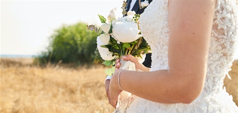 bride in wedding dress holding flowers