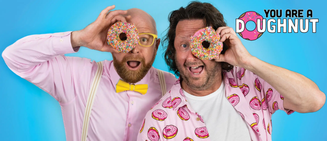 Two performers holding doughnuts